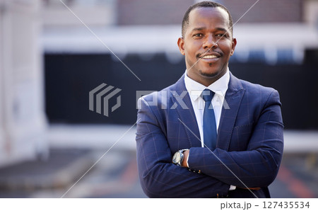 Corporate, black man and smile in portrait with arms crossed in city, town or metro in government. African politician, happy and vision with motivation, professional confidence or leadership in suit 127435534