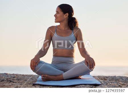 Yoga, meditation or zen exercise black woman relax on yoga mat at beach, sea or ocean for motivation, wellness or workout. Sunset, happy or girl portrait on sand for sport, chakra energy or training 127435597
