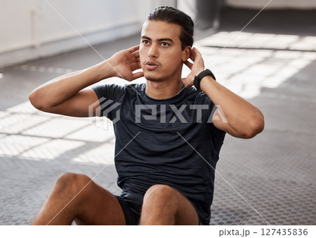 Fitness, health or man training sit ups in gym for sport exercise, wellness or workout motivation for personal goal. Focus, body energy or athlete male in studio for core or stomach strength on floor 127435836
