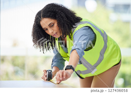 Table, design and woman with measuring tape for woodworking, interior design and renovation, size and construction. Furniture, builder and creative woman check desk measurement for building project 127436058