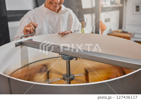 Machine, beekeeper and honey in production in a factory at sustainable, agriculture and agro bee farm. Mixer, manufacturing and woman farmer in warehouse to produce organic, natural and raw honeycomb 127436117