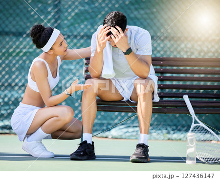 Tennis, sad and woman talking to man with stress, headache or head injury on outdoor court. Fitness, sports and girl athlete speaking to upset boyfriend for motivation, help and care on tennis court. Tennis, sad and woman talking to man with stress, headache or head injury on outdoor court. Fitness, sports and girl athlete speaking to upset boyfriend for motivation, help and care on tennis court. 127436147