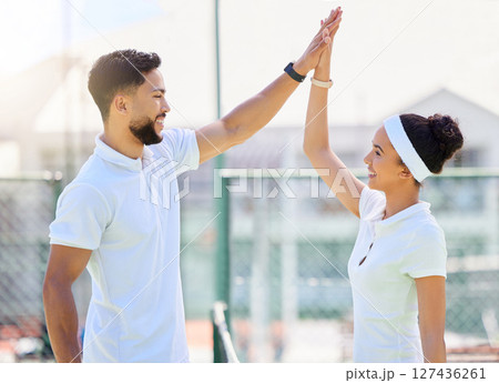 Tennis, high five and motivation with a sports couple in celebration of an achievement as a winner team. Fitness, workout and success with a man and woman tennis player on a tennis court together Tennis, high five and motivation with a sports couple in celebration of an achievement as a winner team. Fitness, workout and success with a man and woman tennis player on a tennis court together 127436261