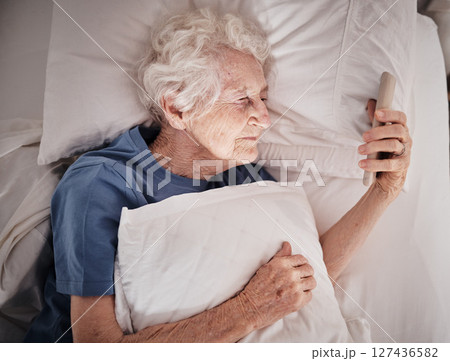 Bad vision, senior woman and phone on bed in bedroom home texting, social media or internet browsing. Blurred eyesight, retired and elderly female with smartphone squinting and trying to read message Bad vision, senior woman and phone on bed in bedroom home texting, social media or internet browsing. Blurred eyesight, retired and elderly female with smartphone squinting and trying to read message 127436582