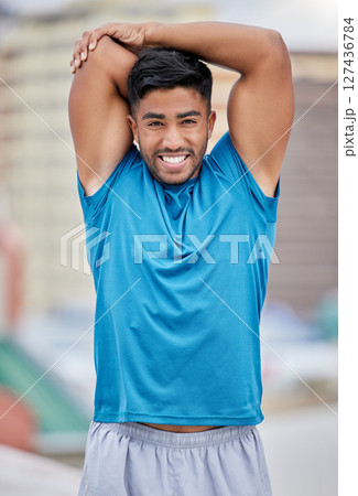 Portrait, fitness and man stretching arms in city getting ready for exercise, training or workout. Sports, healthcare and happy male athlete warm up outdoors for wellness, flexibility or mobility. 127436784