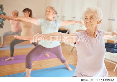 Exercise, yoga and group of senior women in gym training for fitness, healthcare and wellness. Pilates, meditation and retired females stretching arms in fitness center for balance workout together. Exercise, yoga and group of senior women in gym training for fitness, healthcare and wellness. Pilates, meditation and retired females stretching arms in fitness center for balance workout together. 127436932