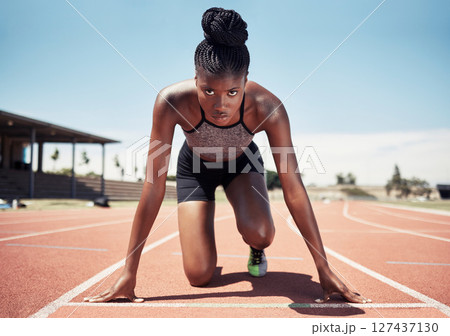 Black woman, runner and start line, race and competition, exercise challenge or fitness at stadium arena. Portrait, focus and sports athlete ready on running track, marathon training and cardio power 127437130