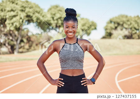 Portrait, black woman and athlete with smile, outdoor and health for wellness, workout and happy on track field. Runner, African American female and confident girl for training, exercise and fitness. Portrait, black woman and athlete with smile, outdoor and health for wellness, workout and happy on track field. Runner, African American female and confident girl for training, exercise and fitness. 127437155
