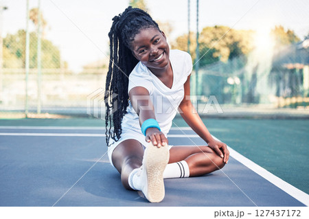 Tennis, fitness and stretching woman on floor in sports court for health, wellness and competition training in happy portrait. African athlete ground warm up or exercise for muscle, energy and legs 127437172