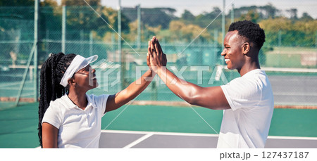 High five, tennis and sports couple or black people with success, competition congratulations or support in game collaboration. Tennis court, athlete and fitness friends with mission or yes hand sign High five, tennis and sports couple or black people with success, competition congratulations or support in game collaboration. Tennis court, athlete and fitness friends with mission or yes hand sign 127437187