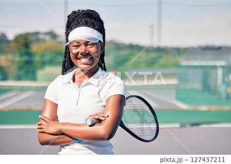 Tennis, athlete and portrait of black woman on a court with a racket before training or match. Sports, fitness and happy African lady with smile standing on outdoor tennis court for game or workout. 127437211