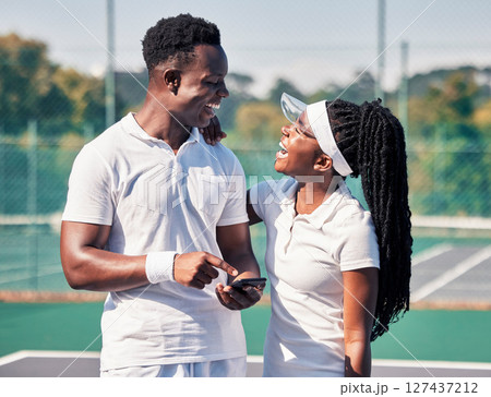Black couple, tennis and phone, laughing or smile for online communication or social media fitness. African man, woman and happy tennis player streaming comic video or workout motivation on court 127437212