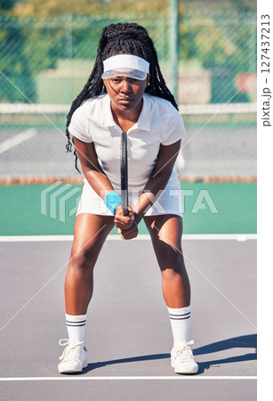 Tennis, sports and portrait of black woman on court ready for game, match or competition. Healthcare, fitness and female tennis player on field preparing for training practice outdoors for exercise. 127437213