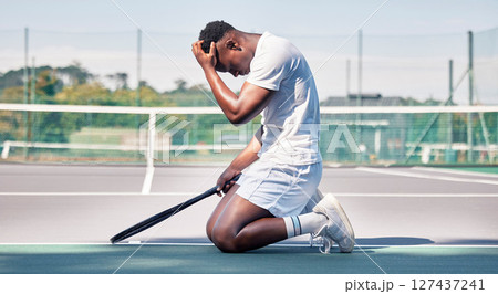 Tennis court, mistake and black man with depression, stress and mental health problem of anxiety after sports training, workout and exercise. Athlete model sad after loss, failure and burnout outdoor Tennis court, mistake and black man with depression, stress and mental health problem of anxiety after sports training, workout and exercise. Athlete model sad after loss, failure and burnout outdoor 127437241