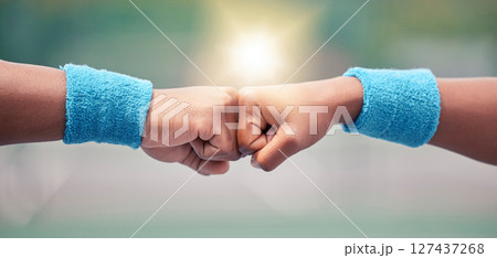 Tennis, closeup and fist bump for success, motivation and teamwork with blurred background while outdoor. Tennis player, hands and touch for respect, team building and support at training in summer Tennis, closeup and fist bump for success, motivation and teamwork with blurred background while outdoor. Tennis player, hands and touch for respect, team building and support at training in summer 127437268