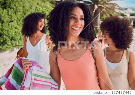 Happy, woman and friends on a summer beach with smile for holiday break, vacation or travel in the outdoors. African American women smiling and enjoying a fun social day together at the ocean coast 127437443