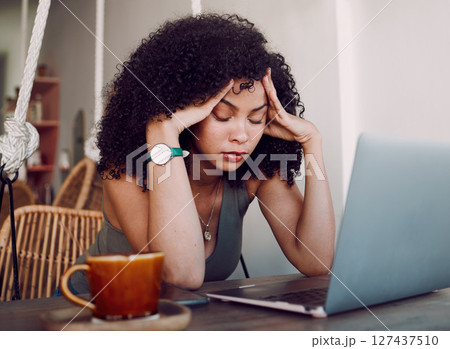 Black woman, laptop and headache from stress, anxiety or overworked in remote business at home. African American female holding head and suffering from burnout, mental health issues or bad difficulty 127437510