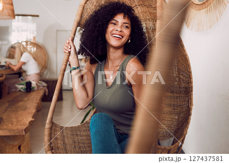 Black woman, happy smile and sitting in chair, coffee shop and freedom, afro and relax with positive mindset. Gen z girl, cafe and happiness, weekend and carefree while relaxing, laugh and joy 127437581