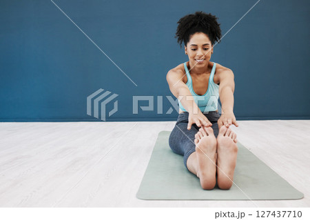 Black woman, yoga mat or studio stretching in pilates healthcare class or zen wellness center on blue wall mockup. Smile, happy or relax yogi in flexibility workout training or fitness floor exercise 127437710