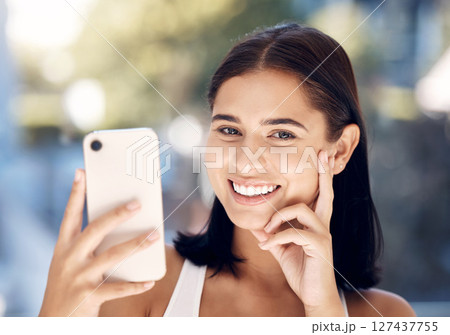Phone, selfie and portrait of a woman in a bathroom for skincare, beauty and cleaning against blurred background mockup. Face, girl and smile for picture after facial treatment, grooming and hygiene Phone, selfie and portrait of a woman in a bathroom for skincare, beauty and cleaning against blurred background mockup. Face, girl and smile for picture after facial treatment, grooming and hygiene 127437755