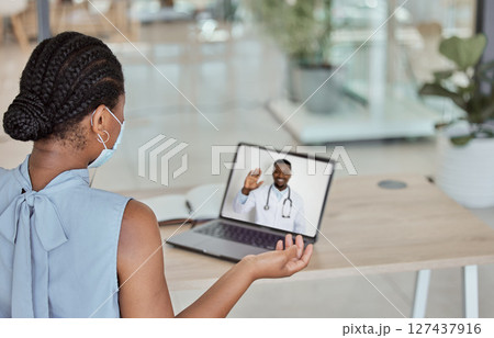 Patient, video call and covid black woman on a laptop screen meeting with doctor online with a mask. Healthcare, medical and corona with a female and health professional virtual consulting or advice 127437916