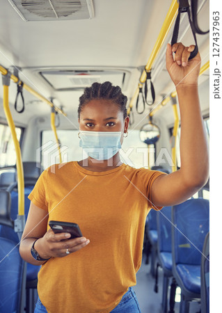 Bus, public transport and black woman with phone and covid face mask during travel for safety compliance and health. Portrait of female during covid 19 with smartphone for communication and schedule Bus, public transport and black woman with phone and covid face mask during travel for safety compliance and health. Portrait of female during covid 19 with smartphone for communication and schedule 127437963