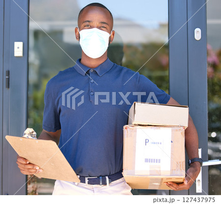 Delivery, black man and covid face mask with a box and clipboard at door for export courier service with safety compliance. Logistics, ecommerce and shipping worker with package during coronavirus Delivery, black man and covid face mask with a box and clipboard at door for export courier service with safety compliance. Logistics, ecommerce and shipping worker with package during coronavirus 127437975