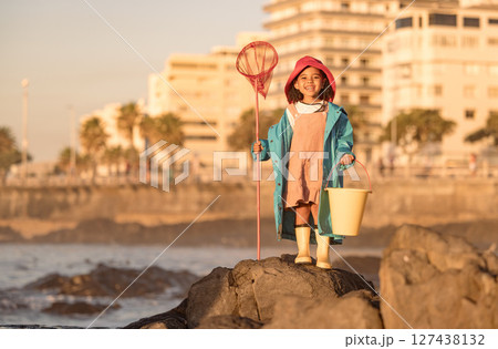 Girl, fishing and beach adventure for freedom, peace and learning skill development. Child, happy and ready with fishing net, bucket and fun outdoor activity, portrait and happiness in sunshine Girl, fishing and beach adventure for freedom, peace and learning skill development. Child, happy and ready with fishing net, bucket and fun outdoor activity, portrait and happiness in sunshine 127438132
