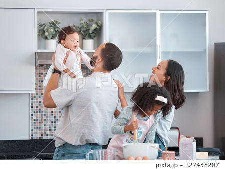 Family, children and baking with a father, mother and daughter siblings in the kitchen learning to bake. Food, cooking and love with a man, woman and girl children having fun at home together 127438207