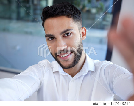 Businessman, portrait smile and selfie at the office for social media, profile or status update. Happy man employee face smiling in happiness for photo, career or new job startup at the workplace 127438214