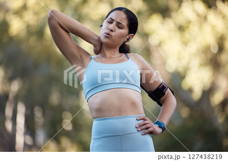Fitness, exercise and neck pain with a sports woman holding a muscle or joint injury during an outdoor workout in nature. Training, health and anatomy with a female athlete suffering with a strain 127438219
