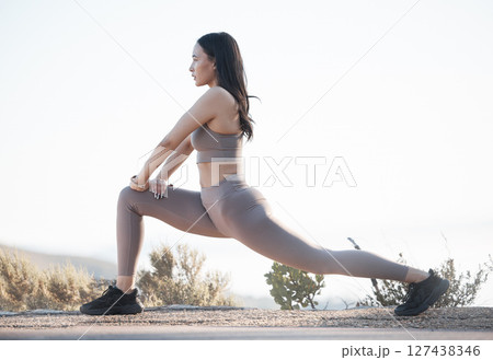 Fitness, exercise and woman stretching outdoor on a mountain road for health and wellness with cardio training. Athlete or sports model doing a workout in nature to prepare for a marathon or race 127438346