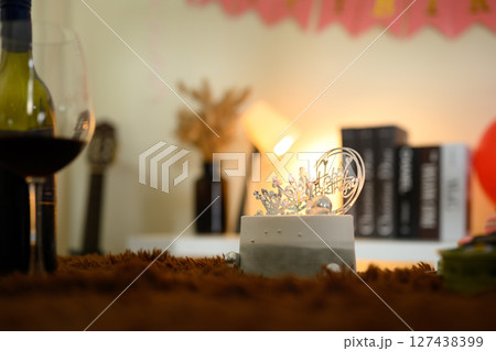 Elegant birthday cake with crown and Happy Birthday topper set on a cozy table with soft lighting Elegant birthday cake with crown and Happy Birthday topper set on a cozy table with soft lighting 127438399