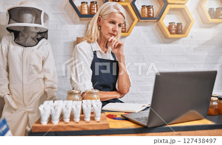 Shop, stress and anxiety of owner at laptop with inflation, debt or bankruptcy update. Fear, risk and bills of professional honey store manager checking finance report online with worry. 127438497