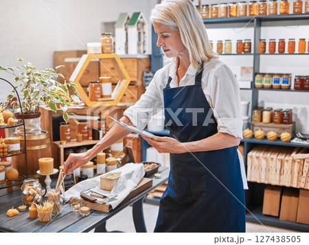 Small business owner, honey store and woman with tablet for inventory, ecommerce and online sales in sustainable organic grocery store. Startup, female and stock list technology for product website 127438505