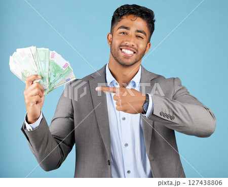Man, cash and hand in portrait at studio for winning, success and profit with smile, prize or investment, Happy businessman, money and winner with happiness, rich or celebration from betting game 127438806