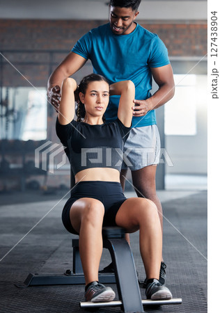 Training, weights and woman with a personal trainer for help during exercise, fitness and motivation in the gym. Health, strong and girl athlete with a coach helping with a workout at a club Training, weights and woman with a personal trainer for help during exercise, fitness and motivation in the gym. Health, strong and girl athlete with a coach helping with a workout at a club 127438904