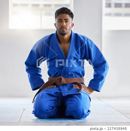 Karate, training and portrait of a coach ready for martial arts, fight and self defense sport at a gym. Fitness, focus and man in a uniform with a brown belt in taekwondo at a studio for sports 127438948