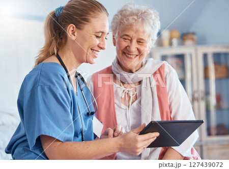 Nursing home, senior patient and nurse with tablet, medical exam results or digital report of stethoscope heart test. Medical support, communication and happy old woman consulting healthcare worker 127439072