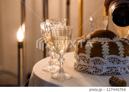 Festive Christmas Scene: Champagne Pouring into Glasses with Gingerbread Cake, Warm Lighting, Cozy Holiday Celebration 127440768