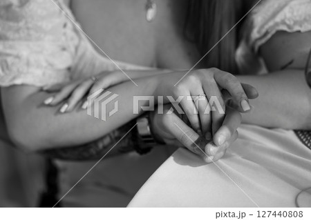 Romantic Wedding Rings Exchange: Intimate Close-Up of Hands Holding Together, Silver Bands, Black and White Photography, Love, Commitment, Marriage. Romantic Wedding Rings Exchange: Intimate Close-Up of Hands Holding Together, Silver Bands, Black and White Photography, Love, Commitment, Marriage. 127440808