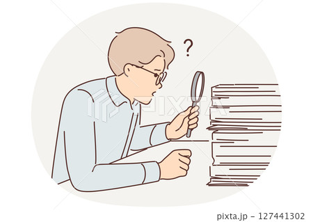 Man auditor looking for errors in financial statements by looking through pile documents via loupe Man auditor looking for errors in financial statements by looking through pile documents via loupe 127441302
