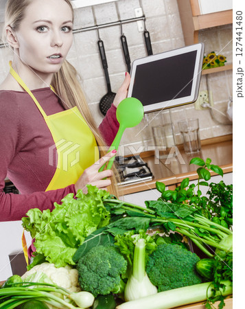 Woman having green vegetables thinking about cooking 127441480
