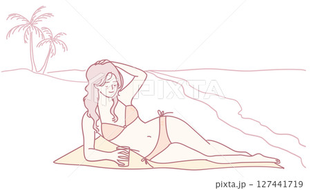 A Lovely Woman Enjoying Relaxation on a Beach with a Refreshing Drink in a Tropical Paradise 127441719