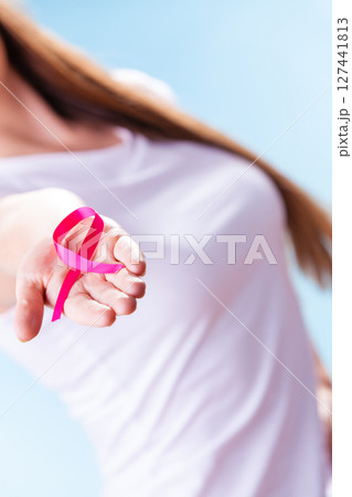 Woman with breast cancer awareness ribbon on hand Woman with breast cancer awareness ribbon on hand 127441813