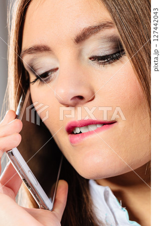 Smiling young woman use phone. 127442043