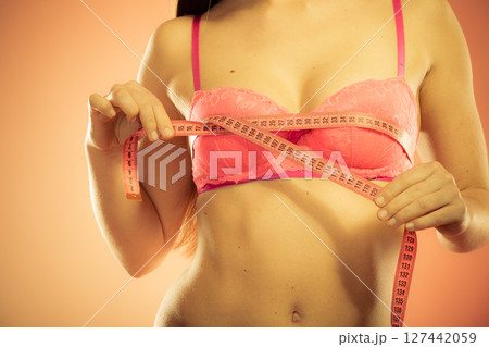 woman measuring her breasts 127442059