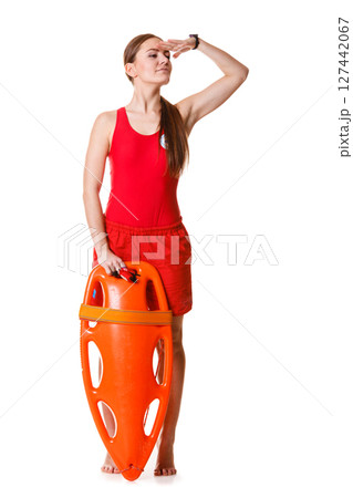 Lifeguard with rescue buoy supervising. 127442067
