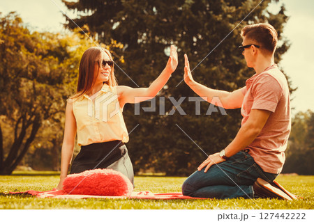 Cheerful couple having fun in park. Cheerful couple having fun in park. 127442222