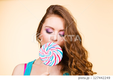 Woman joyful girl with lollipop candy Woman joyful girl with lollipop candy 127442249
